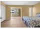 Bright bedroom featuring tile floors, a large window, and a comfortable bed with a fish-themed comforter at 3018 59Th S St # 209, Gulfport, FL 33707