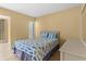 This bedroom features a comfy bed with a fish themed comforter and neutral walls at 3018 59Th S St # 209, Gulfport, FL 33707