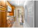 Galley kitchen with wood cabinetry, granite countertops, stainless steel appliances, and tile floors at 3018 59Th S St # 209, Gulfport, FL 33707