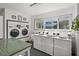 Bright laundry room offering multiple commercial-sized washers and dryers and counter space for folding at 3018 59Th S St # 209, Gulfport, FL 33707