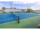 Well-maintained tennis court with blue and green surface, net and adjacent kayak storage area at 3018 59Th S St # 209, Gulfport, FL 33707
