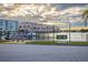 Scenic waterfront view with swing set, boat dock, palm trees, and well-maintained apartment buildings at 3018 59Th S St # 209, Gulfport, FL 33707