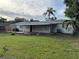 Wide view of the backyard featuring a lawn and a covered back patio at 3118 Adrian Ave, Largo, FL 33774
