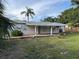 The backyard features a well-maintained lawn and wooden fence that runs along the perimeter at 3118 Adrian Ave, Largo, FL 33774