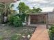 Backyard features a covered gazebo with wooden decking and tropical plants at 3118 Adrian Ave, Largo, FL 33774