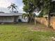 Wide view of the backyard featuring a lawn and a wood fence at 3118 Adrian Ave, Largo, FL 33774