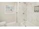 Bright, stylish bathroom with marble shower, and open shelves for storage at 3118 Adrian Ave, Largo, FL 33774