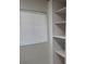 Bathroom featuring a built-in shelving unit and a window with closed blinds at 3118 Adrian Ave, Largo, FL 33774
