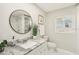 Bright bathroom featuring a marble vanity, modern fixtures, and natural light at 3118 Adrian Ave, Largo, FL 33774