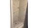 Walk-in shower features decorative accent tiles and a built in shelf at 3118 Adrian Ave, Largo, FL 33774