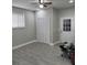 A bedroom features gray flooring, light gray walls, ceiling fan, window, and a closet at 3118 Adrian Ave, Largo, FL 33774
