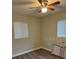 Bedroom with wood-look floors, a ceiling fan, and two windows with blinds at 3118 Adrian Ave, Largo, FL 33774