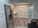 View from the kitchen to the dining room with hardwood floors and modern light fixture at 3118 Adrian Ave, Largo, FL 33774