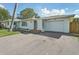 Charming single-story home featuring a well-maintained lawn and attached one-car garage at 3118 Adrian Ave, Largo, FL 33774