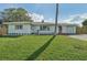 Charming single story home with a well maintained front yard, driveway, and attached garage at 3118 Adrian Ave, Largo, FL 33774