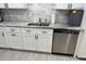 Kitchen with stainless steel appliances, white cabinets, and granite countertops at 3118 Adrian Ave, Largo, FL 33774