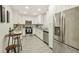 Modern kitchen with stainless steel appliances, white cabinets, and a breakfast bar at 3118 Adrian Ave, Largo, FL 33774