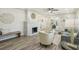 Cozy living room with a stone fireplace, wood flooring, and ample natural light at 3118 Adrian Ave, Largo, FL 33774