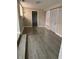 Spacious living room with wood-look tile flooring and natural light at 3118 Adrian Ave, Largo, FL 33774