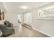 Spacious living room with stylish gray accent chairs, hard floors, and a view into the bedroom at 3118 Adrian Ave, Largo, FL 33774