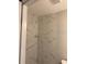 Shower with marble patterned tile and silver hardware at 3118 Adrian Ave, Largo, FL 33774