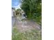 A side yard featuring a wood fence and room for storage or other outdoor activities at 3118 Adrian Ave, Largo, FL 33774