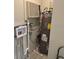 Utility closet with gray water heater and a small air conditioner at 3118 Adrian Ave, Largo, FL 33774
