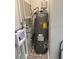 Utility closet with gray water heater and a small air conditioner at 3118 Adrian Ave, Largo, FL 33774