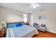 Comfortable bedroom with hardwood floors, ceiling fan, and a sitting area at 320 Broadway, Dunedin, FL 34698