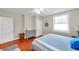 Bright bedroom featuring hardwood floors, a window for natural light, and neutral tones at 320 Broadway, Dunedin, FL 34698