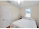 Bright bedroom features hardwood floors, a window for natural light, and a ceiling fan at 320 Broadway, Dunedin, FL 34698