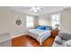 Serene bedroom with hardwood floors, natural light, and a comfortable queen-sized bed at 320 Broadway, Dunedin, FL 34698