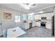 Bright kitchen with white cabinets, stainless steel appliances, and a cozy dining area at 320 Broadway, Dunedin, FL 34698