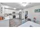 Bright kitchen features white cabinetry, stainless appliances, tile floors, and a ceiling fan at 320 Broadway, Dunedin, FL 34698