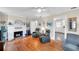 Inviting living room showcasing hardwood floors, a fireplace, and an open layout to other rooms at 320 Broadway, Dunedin, FL 34698