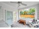 Enclosed sunroom with sliding doors, tile flooring, and backyard views at 320 Broadway, Dunedin, FL 34698
