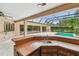 Outdoor wet bar area adjacent to screened in pool and spa at 3308 Landing Pl, Palm Harbor, FL 34684