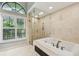 Bright bathroom showcasing a soaking tub with a glass enclosed shower at 3308 Landing Pl, Palm Harbor, FL 34684