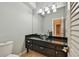 Elegant bathroom vanity with a vessel sink, granite countertop, and modern lighting fixtures at 3308 Landing Pl, Palm Harbor, FL 34684