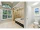 Bright bathroom showcasing a soaking tub with a glass enclosed shower at 3308 Landing Pl, Palm Harbor, FL 34684