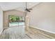 Bright bedroom featuring wood flooring and a view of the screened-in pool area at 3308 Landing Pl, Palm Harbor, FL 34684