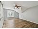 Bright bedroom featuring wood flooring, a window with shutters, and a modern ceiling fan at 3308 Landing Pl, Palm Harbor, FL 34684