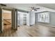 Bright bedroom with wood floors, walk-in closet, bay window with shutters, and a modern ceiling fan at 3308 Landing Pl, Palm Harbor, FL 34684