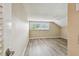 Cozy bedroom featuring wood flooring and a window with shutters at 3308 Landing Pl, Palm Harbor, FL 34684