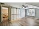 Inviting bedroom featuring hardwood floors, sliding closet doors, and a window seat for relaxation at 3308 Landing Pl, Palm Harbor, FL 34684