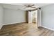 Bright bedroom with wood floors, walk-in closet, and a modern ceiling fan at 3308 Landing Pl, Palm Harbor, FL 34684