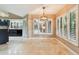 Bright dining area open to the kitchen with shuttered windows overlooking the pool at 3308 Landing Pl, Palm Harbor, FL 34684