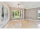 Bright dining room with shuttered windows, modern lighting and tile floors at 3308 Landing Pl, Palm Harbor, FL 34684