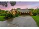 Charming home with well-manicured landscaping, a spacious driveway, and a two-car garage at 3308 Landing Pl, Palm Harbor, FL 34684