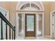 Elegant foyer featuring a decorative glass door, transom window and tile flooring at 3308 Landing Pl, Palm Harbor, FL 34684